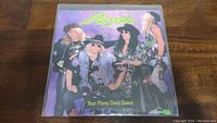 Front cover of Poison Your Mama Don't Dance 45rpm vinyl record single, showing band members in 1980's glam metal fashion