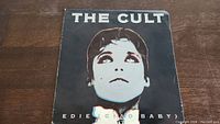 Front cover of The Cult Edie (Ciao Baby) 45rpm vinyl single sleeve showing stylized portrait and text.