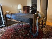Side view showing bed frame, rails, mattress and attached pump controller