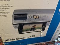 Box front showing HP Photosmart 8150 photo printer graphic with photo output on paper visible.