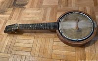 Full view of the Keech banjo ukulele showing body, neck and headstock