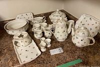 Full assortment of 18 porcelain pieces arranged on countertop