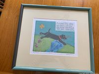 Framed limited edition print of a black dog running with a stick and a poem, shown fully matted and framed.