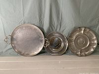 Photo showing three aluminum trays of different sizes and designs placed side by side.