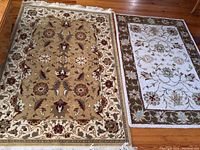 Both area rugs laid flat on the floor showing size comparison, colors, and patterns clearly.