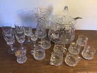 Full view of the set on wood surface includes punch bowl, punch cups, wine glasses, vase, and toothpick holder.