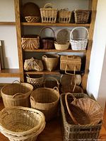 Detailed image of shelving unit with additional assorted wicker baskets, showing smaller sizes and different woven patterns including white-painted basket.