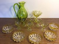 Overview of all items: 6 green sherry glasses, 5 amber edged bowls, Pernod cut glass candy dish, green glass pitcher
