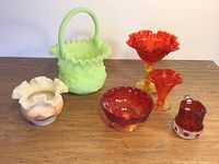 Photo showing all items in the set: lime green floral basket, frosted milk glass hand-painted candle holder, and four red/orange glass pieces