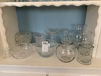 Full view of all 12 glassware items arranged on shelf.