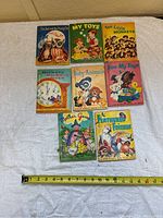 Eight vintage Junior Elf children's books laid out flat, showing cover art and approximate 5x6 inch size.