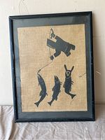 Front view of framed artwork showing stylized fishing scene on burlap background