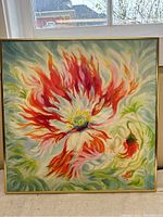 Front view of colorful abstract flower oil painting on canvas framed in gold trim.