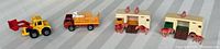 Photo showing yellow front loader, orange cattle truck with white toy cattle, beige mobile horse stables and beige horse trailer with red toy horses and cattle