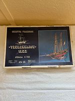 Top view of the model ship kit box with image of completed Toulonnaise 1823 two-masted ship and brand info on lid.