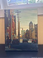 Frontal view of painting depicting city street scene