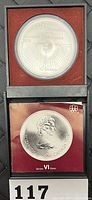 Photo showing front and back of the silver coin in presentation box with label '117'.