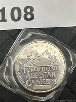 Back of coin showing 'TORONTO '91 ALL-STAR GAME 1', maple leaf, stars and serial number 4827.