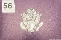 Front cover of the proof set folder showing purple leatherette texture with white embossed Great Seal of the United States.