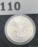 Obverse side of the 2014 Canada 1oz silver coin showing a detailed peregrine falcon in flight, purity and weight markings, housed in a clear protective capsule.
