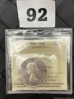 Obverse side of the 1964 Canadian 50 cent silver coin showing Queen Elizabeth II's portrait and grading information.