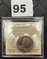 Obverse of graded Canadian 1968 50 cent coin in ICCS holder with certificate visible.