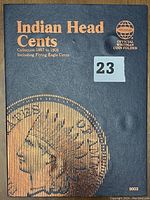 Front cover of the Whitman Indian Head Cents Coin Album in blue with gold lettering displaying title and collection dates 1857 to 1909, including Flying Eagle cents.