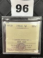 Photo showing obverse side of the 1941 Newfoundland 5 Cent coin in plastic holder with ICCS certification card visible, certification number XKN 069, grade EF-45.