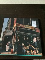 Front cover of the LP showing the storefront with signs including Paul's Boutique and Lee's Sportswear.
