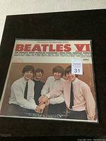 Front view of the Beatles VI album cover showing the band members smiling and posing together.