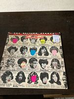 Front of the Some Girls album cover showing Pop Art style images of faces and text.