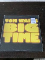 Front cover of the sealed Tom Waits Big Time album showing album title in large yellow bold letters.