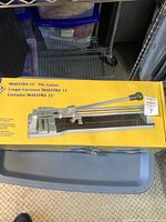 Photo of the Maestro 13-inch tile cutter in yellow box showing the product and brand information.