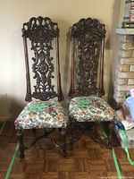 Front view of both chairs showing overall appearance, carving and upholstery