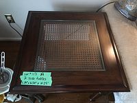 Top view of one wood side table showing glass top with wicker inlay and measurement note.