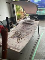 Vintage hammock with butterfly print canopy sunshade showing fabric pattern and metal frame