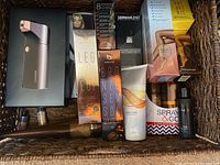 Overview photo of the basket containing Breeze airbrush tanning system box and many bronzing and tanning products.