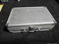 Closed silver aluminum carrying case with latch closure