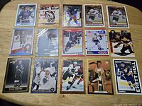 Photo showing 15 vintage NHL hockey cards including multiple Wayne Gretzky cards, Brendan Shanahan, Bobby Hull, Mark Messier, and others.