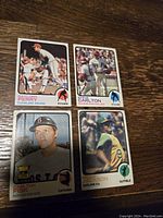 Close-up of four notable 1973 Topps baseball cards featuring Gaylord Perry, Steve Carlton, Carlton Fisk, and Reggie Jackson.