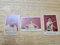 Three vintage Cracker Jack baseball cards showing Honus Wagner, Marquard, and Johnny Evers, each with classic illustrated style frames.