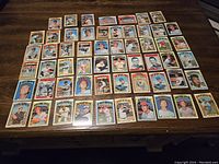 Lot of 59 1972 Topps baseball cards arranged on a wooden surface showing the front of the cards.