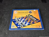 Back of sealed box showing Chicago Cubs and Mets baseball themed chessboard design with detailed figurine pieces as chess pieces.