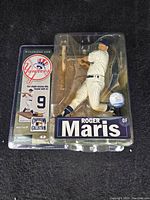 Front view of Roger Maris figurine in blister pack, showing full figure with bat and baseball base.