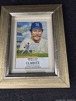 Framed autographed color illustrated portrait of Sparky Lyle with Claridge Casino Hotel advertisement and signatures.