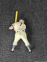 Top view of Mickey Mantle baseball figurine showing pinstriped uniform and yellow bat.