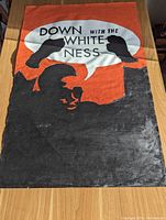 Front of artwork: bold orange background, black silhouettes and white speech bubble reading 'DOWN WITH THE WHITENESS'