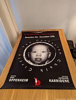 The Caucasian Chalk Circle movie poster laid flat on table, showing full poster with black background and child's face image.