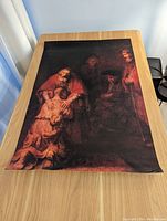 Overview photo of the Michaelangelo Prodigal Son art print laid flat on a wooden table showing the full image and colors.