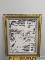 Full view of framed abstract painting with solid wood gold-painted frame and fabric inner mat.